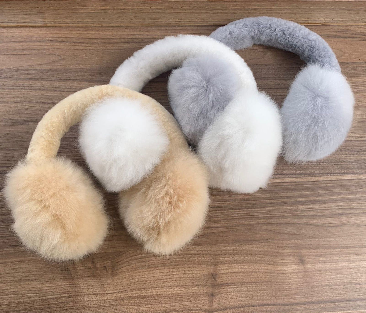 Fluffy alpaca earmuffs in camel, grey and white, handmade by artisans in Peru