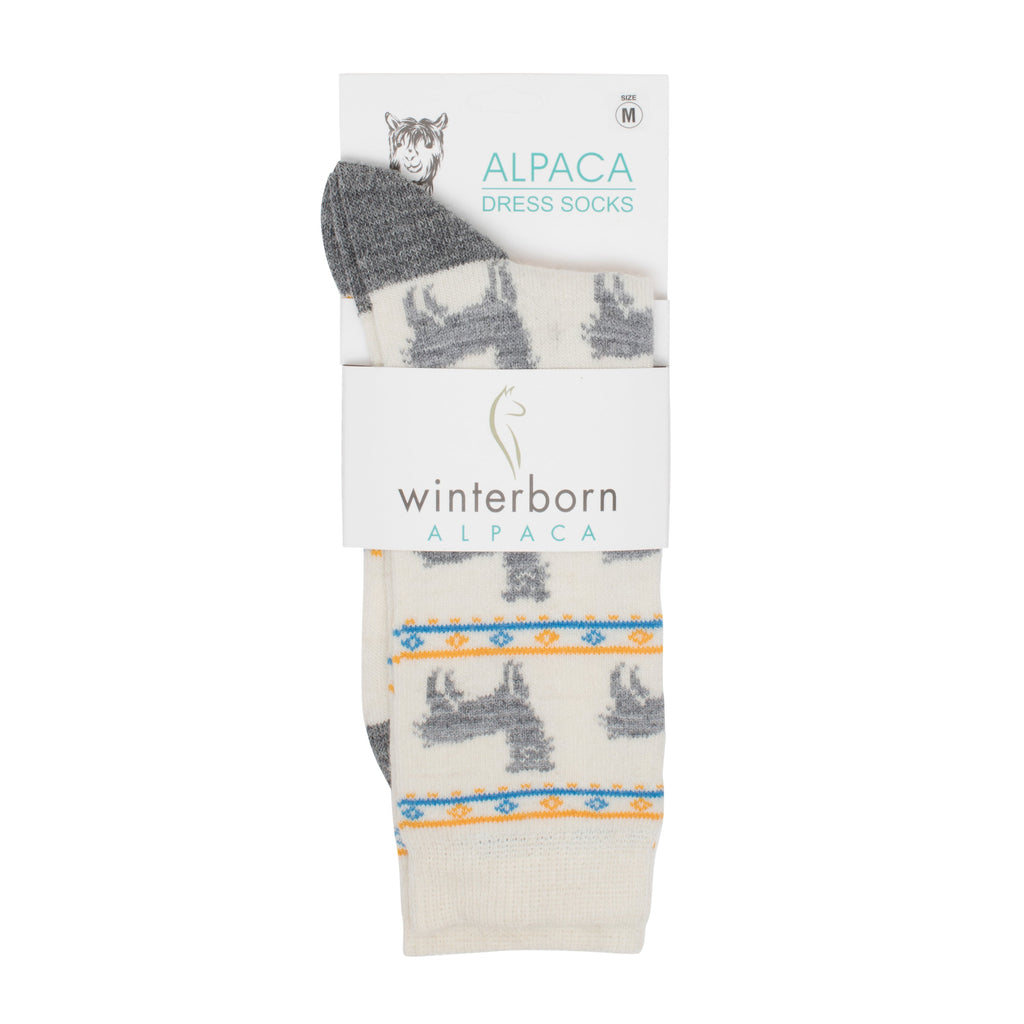 Cream alpaca socks with an alpaca pattern in Winterborn packaging