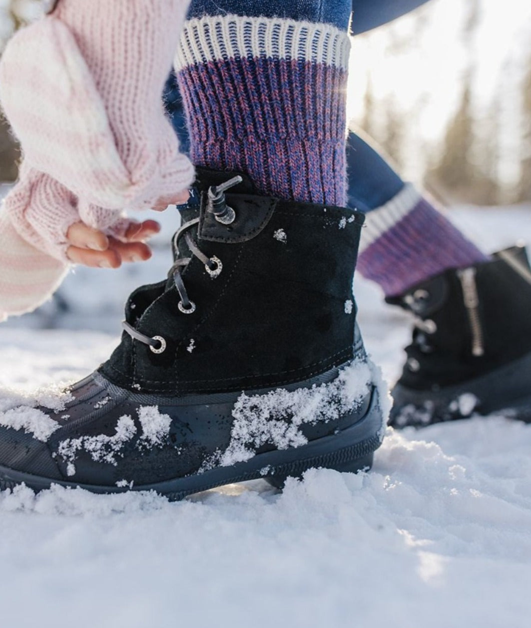 Purple alpaca sport socks worn with laced winter boots in the snow