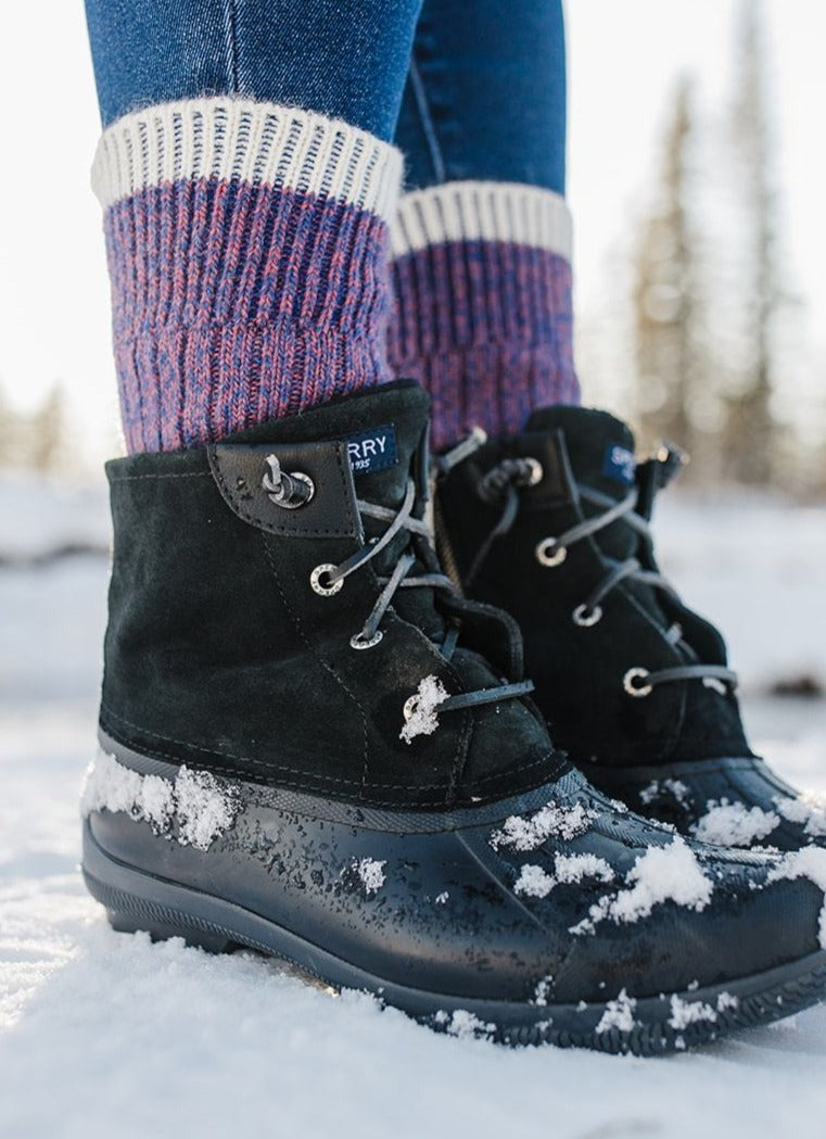 Purple alpaca sport socks worn with winter boots in the snow