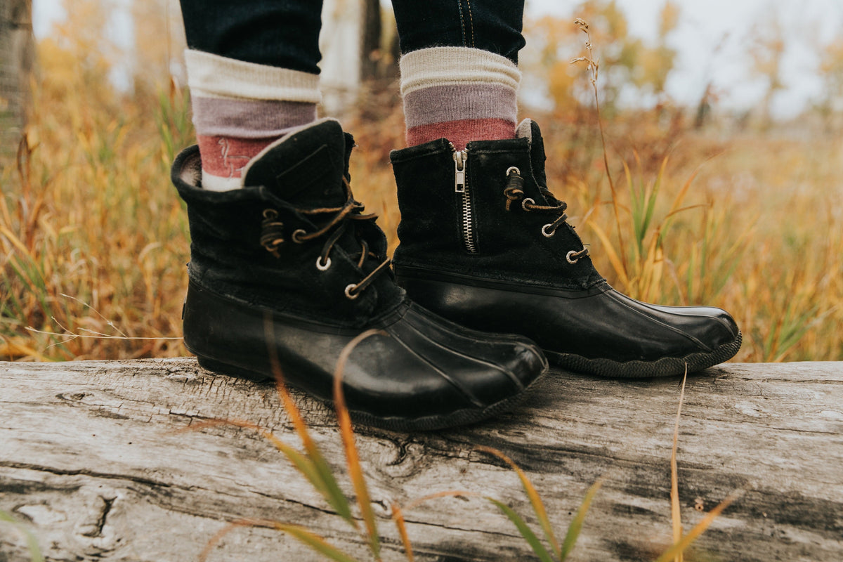 Alpaca socks worn with winter boots outdoors in autumn